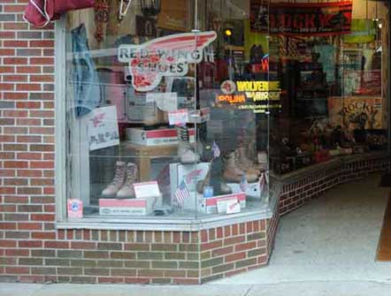 A photo of the left display window at Pauls Clothing and Shoe Store.